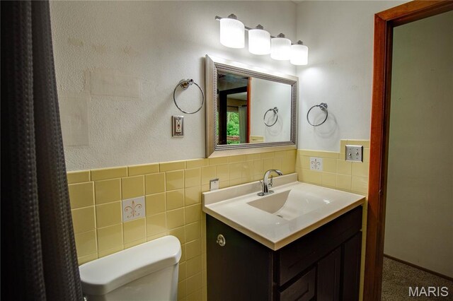 10000 Wondell Woods Dr, Belleville, IL 62223 - bathroom with tile walls, vanity, and a wainscoted wall