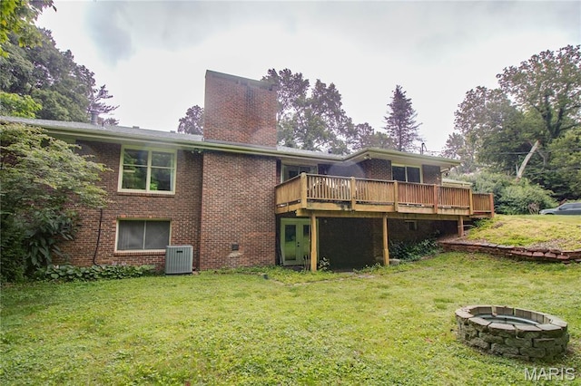 10000 Wondell Woods Dr, Belleville, IL 62223 - rear view of property featuring an outdoor fire pit, a deck, a lawn, a chimney, and brick siding