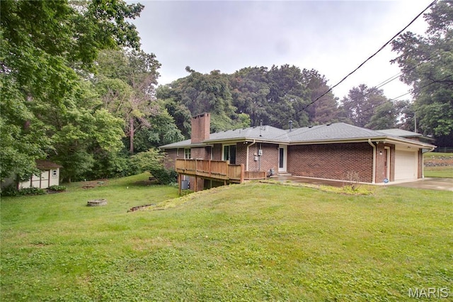 10000 Wondell Woods Dr, Belleville, IL 62223 - back of house featuring a garage, a chimney, a yard, brick siding, and concrete driveway