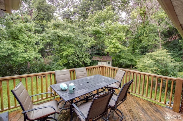 10000 Wondell Woods Dr, Belleville, IL 62223 - wooden deck with outdoor dining space, a shed, and a forest view
