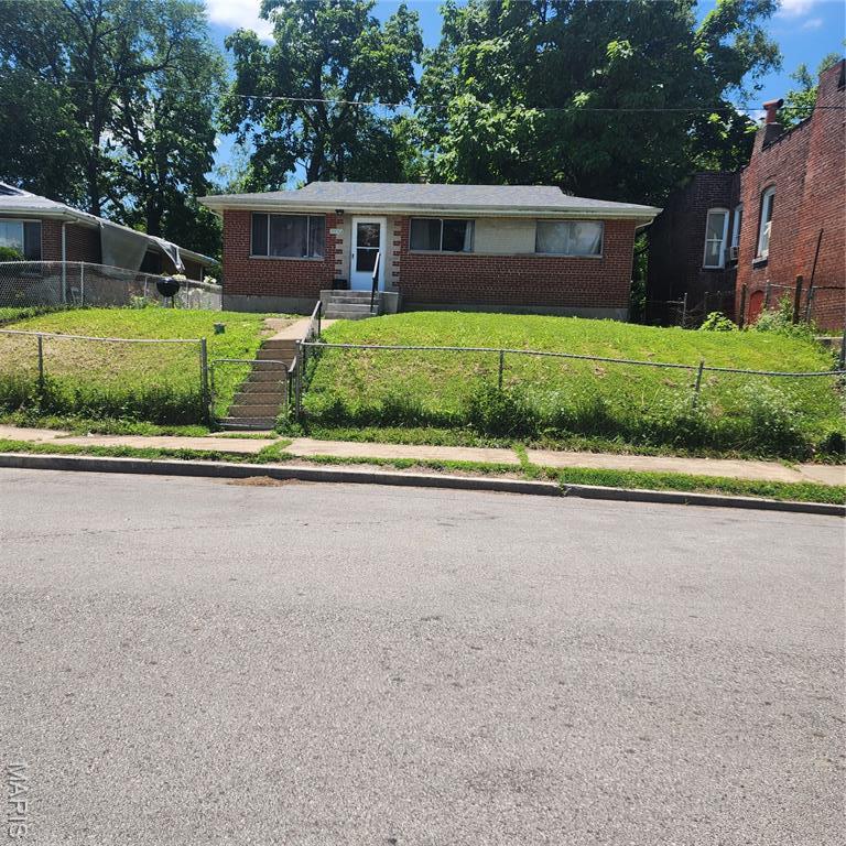 5344 Northland Ave, Saint Louis, MO 63112 - view of front of home with brick siding and a fenced front yard