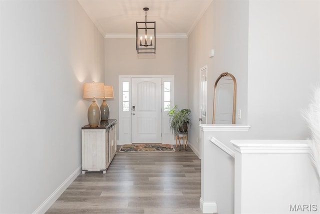 509 Spruce Hollow Ct, Wentzville, MO 63385 - entrance foyer featuring a chandelier, wood finished floors, ornamental molding, and a towering ceiling