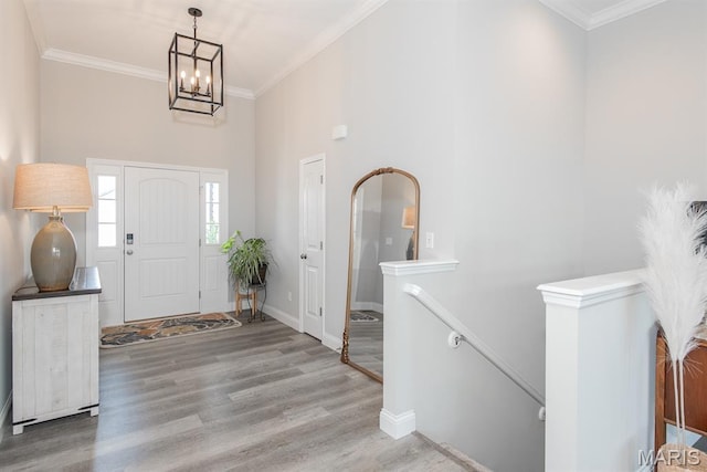 509 Spruce Hollow Ct, Wentzville, MO 63385 - foyer with a high ceiling, a chandelier, wood finished floors, and ornamental molding
