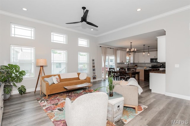 509 Spruce Hollow Ct, Wentzville, MO 63385 - living room featuring plenty of natural light, ornamental molding, a chandelier, ceiling fan, and light wood-type flooring