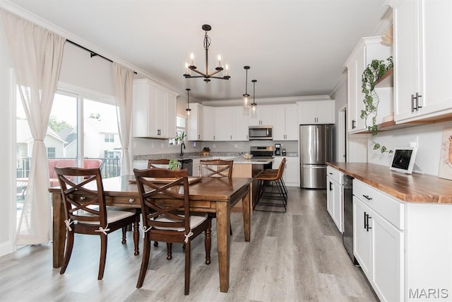 509 Spruce Hollow Ct, Wentzville, MO 63385 - dining area featuring light wood-type flooring and a chandelier