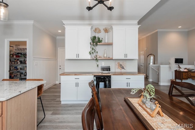 509 Spruce Hollow Ct, Wentzville, MO 63385 - kitchen with open shelves, light wood finished floors, recessed lighting, wainscoting, and crown molding