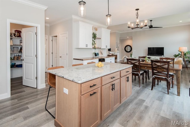 509 Spruce Hollow Ct, Wentzville, MO 63385 - kitchen featuring light wood finished floors, crown molding, a chandelier, light stone countertops, and open floor plan