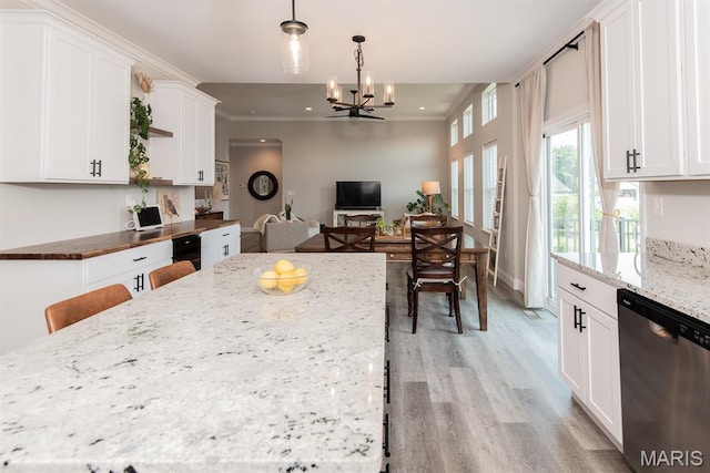 509 Spruce Hollow Ct, Wentzville, MO 63385 - kitchen with stainless steel dishwasher, light wood finished floors, white cabinets, a chandelier, and ornamental molding