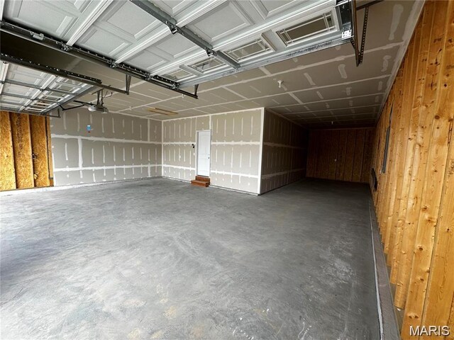 509 Spruce Hollow Ct, Wentzville, MO 63385 - garage with wood walls and a garage door opener