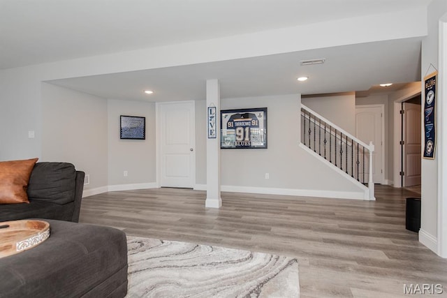 509 Spruce Hollow Ct, Wentzville, MO 63385 - living room with wood finished floors, stairway, and recessed lighting