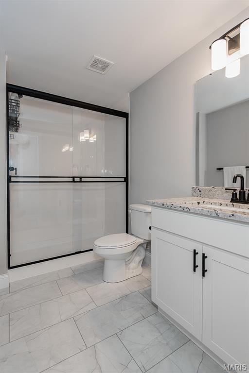 509 Spruce Hollow Ct, Wentzville, MO 63385 - bathroom featuring vanity, marble look tile flooring, and a shower with shower door