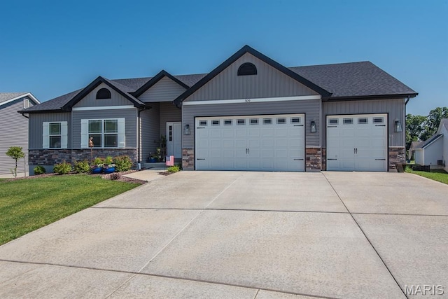 509 Spruce Hollow Ct, Wentzville, MO 63385 - view of front facade with an attached garage, concrete driveway, stone siding, a front lawn, and roof with shingles