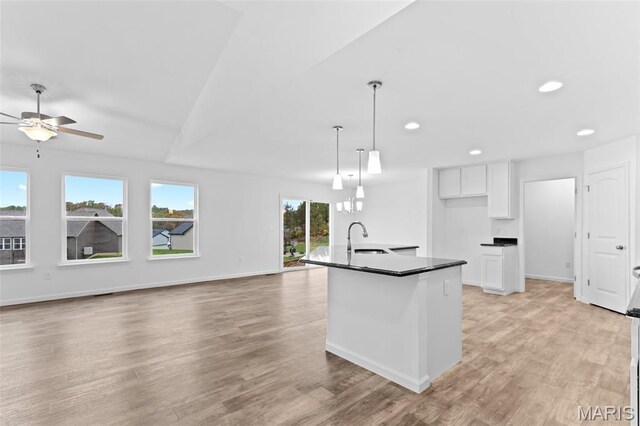 104 Tick Rd, Silex, MO 63377 - kitchen with dark countertops, ceiling fan, white cabinets, recessed lighting, and light wood-style flooring
