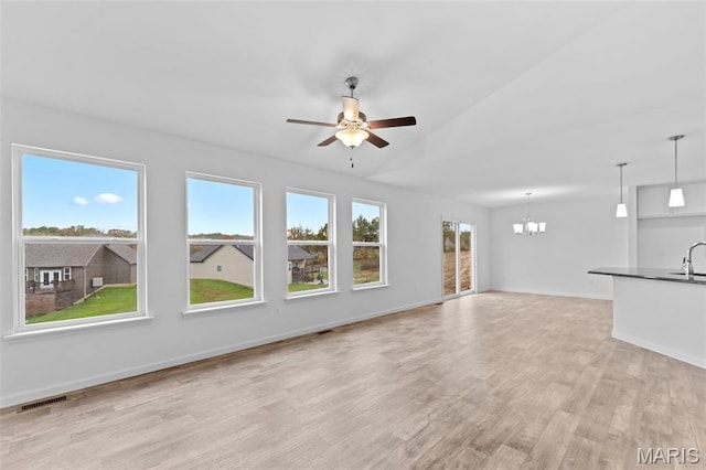 104 Tick Rd, Silex, MO 63377 - unfurnished living room with a chandelier, light wood-style floors, ceiling fan, and vaulted ceiling