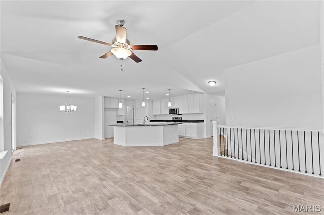 104 Tick Rd, Silex, MO 63377 - unfurnished living room with a ceiling fan, a chandelier, light wood-style flooring, and recessed lighting