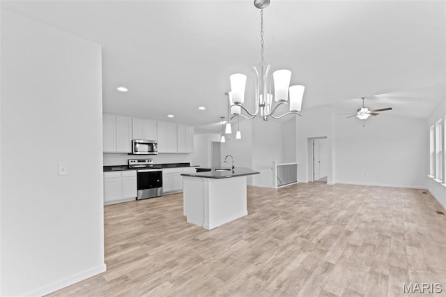 104 Tick Rd, Silex, MO 63377 - kitchen with appliances with stainless steel finishes, dark countertops, white cabinetry, open floor plan, and ceiling fan