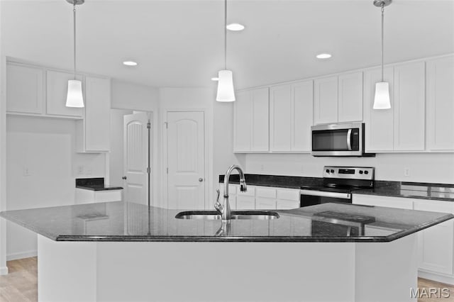 104 Tick Rd, Silex, MO 63377 - kitchen featuring appliances with stainless steel finishes, white cabinetry, a kitchen island with sink, recessed lighting, and dark stone countertops