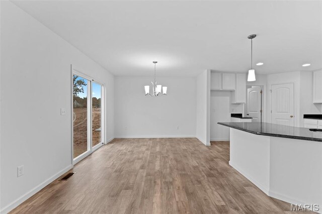 104 Tick Rd, Silex, MO 63377 - kitchen featuring dark countertops, white cabinets, light wood-style flooring, recessed lighting, and a chandelier