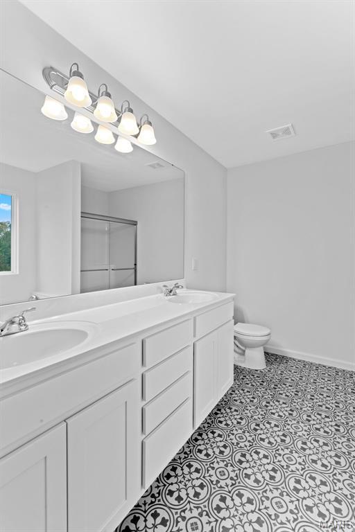 104 Tick Rd, Silex, MO 63377 - full bath featuring double vanity and a shower with shower door