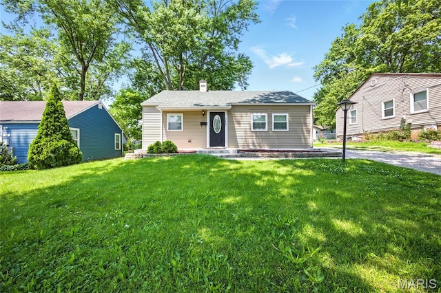 7825 Delmont St, Saint Louis, MO 63123 - view of front facade with a chimney and a front yard