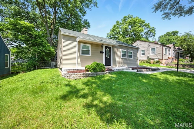 7825 Delmont St, Saint Louis, MO 63123 - view of front of property featuring a chimney, a front lawn, and cooling unit