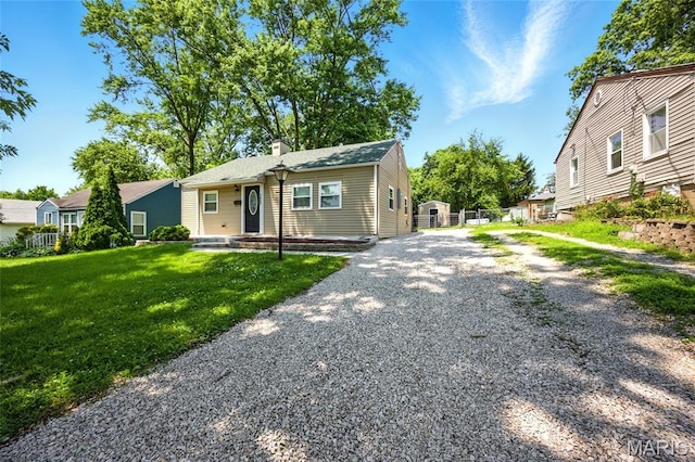 7825 Delmont St, Saint Louis, MO 63123 - bungalow-style house featuring a chimney and driveway
