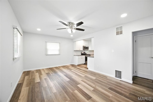 7825 Delmont St, Saint Louis, MO 63123 - unfurnished living room featuring ceiling fan, light wood-style floors, recessed lighting, and baseboards