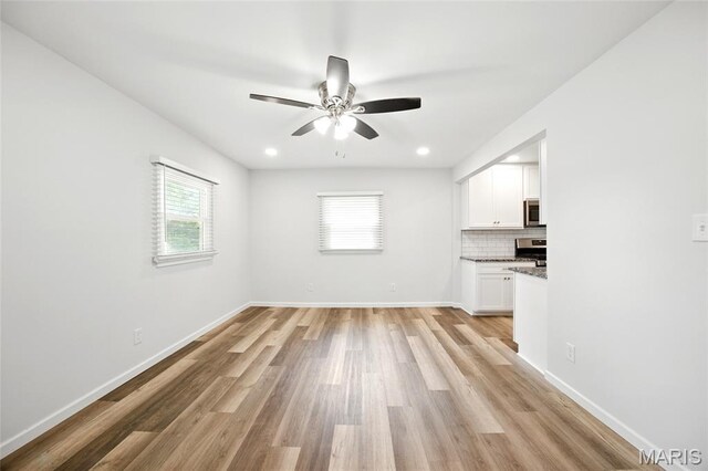 7825 Delmont St, Saint Louis, MO 63123 - unfurnished living room with healthy amount of natural light, a ceiling fan, light wood-type flooring, baseboards, and recessed lighting