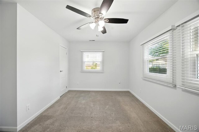 7825 Delmont St, Saint Louis, MO 63123 - spare room with baseboards, carpet flooring, and a ceiling fan