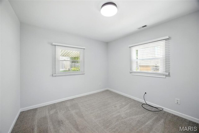 7825 Delmont St, Saint Louis, MO 63123 - unfurnished room featuring plenty of natural light, carpet floors, and baseboards