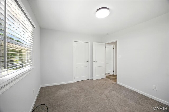 7825 Delmont St, Saint Louis, MO 63123 - unfurnished room featuring carpet floors and baseboards