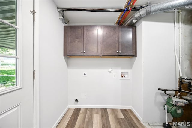 7825 Delmont St, Saint Louis, MO 63123 - laundry area with electric dryer hookup, hookup for a washing machine, wood finished floors, cabinet space, and baseboards