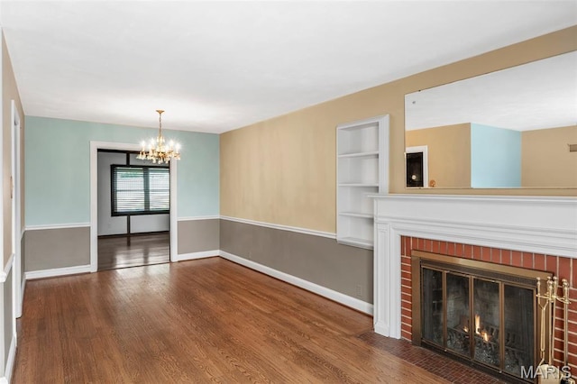 914 Trelane Ave, Crestwood, MO 63126 - unfurnished living room featuring a chandelier, wood finished floors, built in features, and a brick fireplace