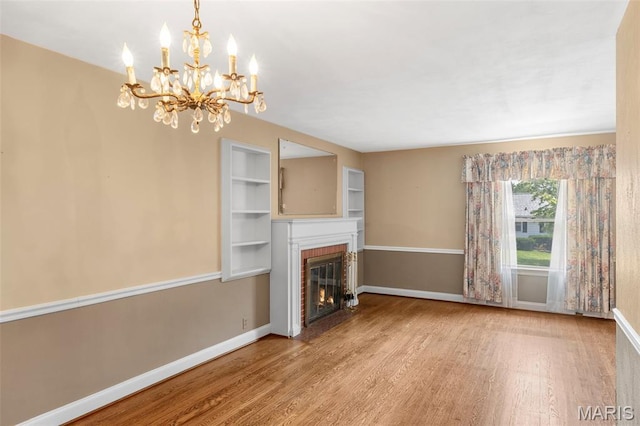 914 Trelane Ave, Crestwood, MO 63126 - unfurnished living room featuring wood finished floors, a fireplace, and a chandelier