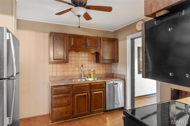 914 Trelane Ave, Crestwood, MO 63126 - kitchen featuring stainless steel appliances, light countertops, decorative backsplash, light wood-type flooring, and ceiling fan