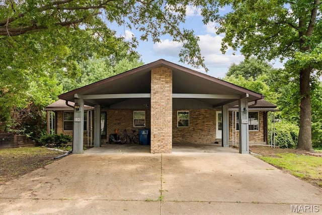 104 Britanna Dr, Swansea, IL 62226 - mid-century modern home with concrete driveway, brick siding, and an attached carport
