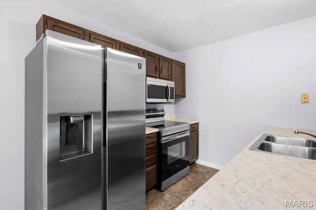 104 Britanna Dr, Swansea, IL 62226 - kitchen with stainless steel appliances, dark brown cabinetry, and light countertops