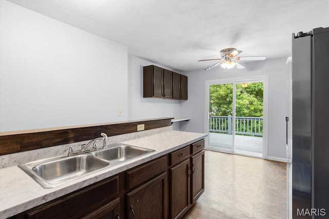 104 Britanna Dr, Swansea, IL 62226 - kitchen with freestanding refrigerator, dark brown cabinetry, ceiling fan, light countertops, and light tile patterned floors