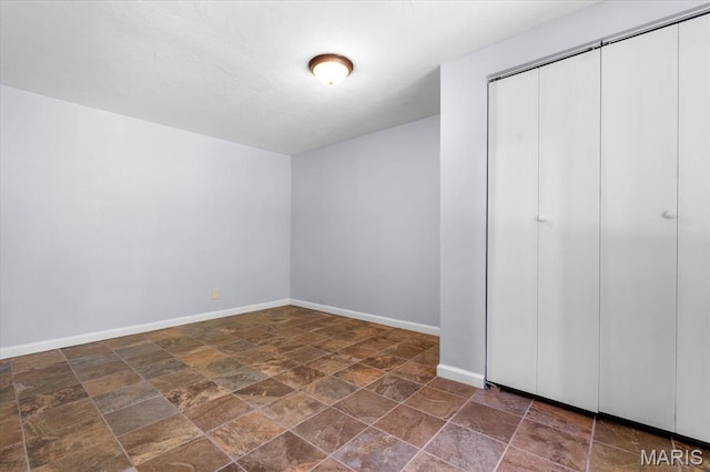 104 Britanna Dr, Swansea, IL 62226 - unfurnished bedroom with stone finish flooring and a closet