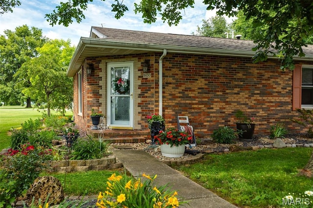 900 Montana St, Gillespie, IL 62033 - doorway to property featuring brick siding and a lawn