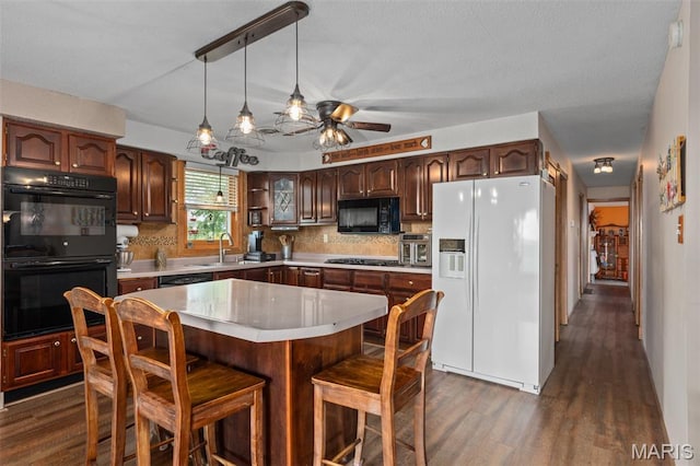 900 Montana St, Gillespie, IL 62033 - kitchen featuring black appliances, light countertops, ceiling fan, dark wood-style flooring, and tasteful backsplash