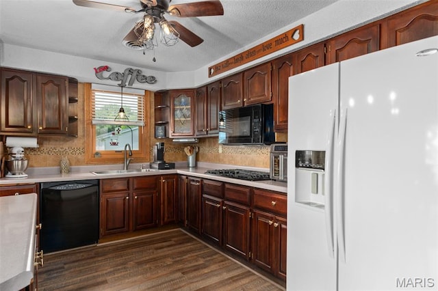 900 Montana St, Gillespie, IL 62033 - kitchen with black appliances, light countertops, decorative backsplash, ceiling fan, and dark wood-style floors