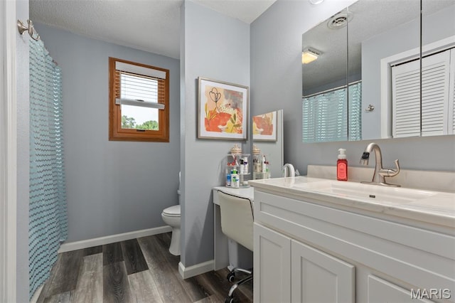 900 Montana St, Gillespie, IL 62033 - bathroom with wood finished floors, vanity, a shower with curtain, and a textured ceiling