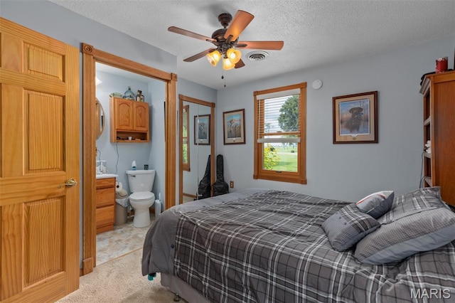 900 Montana St, Gillespie, IL 62033 - bedroom featuring light colored carpet, a textured ceiling, a ceiling fan, and connected bathroom