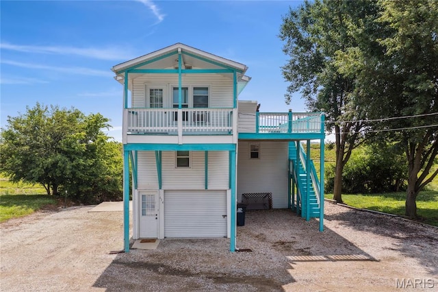 614 Main St, Keyesport, IL 62253 - raised beach house featuring stairs, driveway, and an attached garage