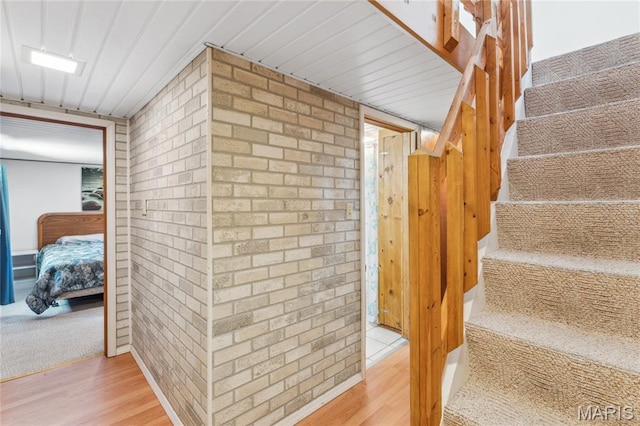 614 Main St, Keyesport, IL 62253 - staircase with wood finished floors and brick wall