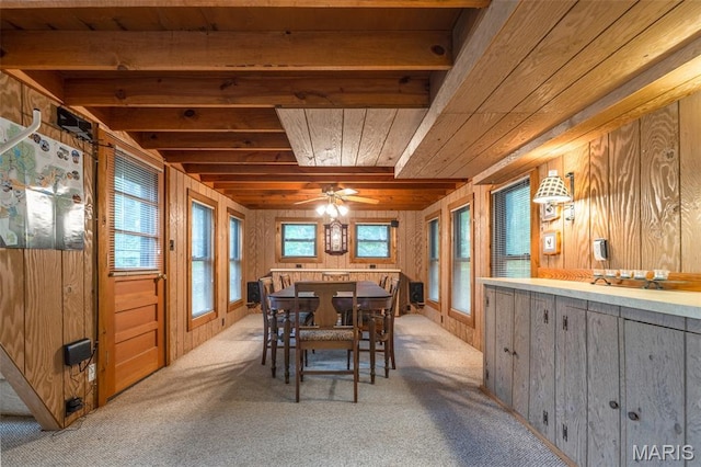 376 W Wanderfern Circle Dr, Innsbrook, MO 63390 - dining room featuring wooden walls, plenty of natural light, wooden ceiling with exposed beams, light carpet, and a ceiling fan