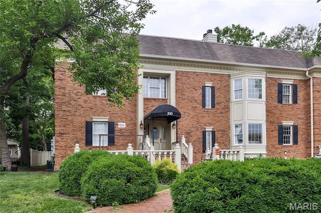 210 N Taylor Ave Unit C, Kirkwood, MO 63122 - view of front of property with brick siding, a chimney, and roof with shingles