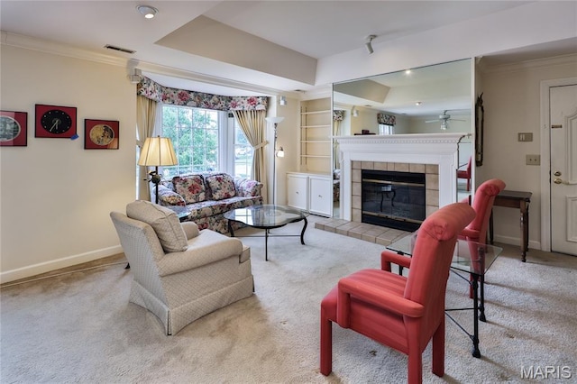 210 N Taylor Ave Unit C, Kirkwood, MO 63122 - carpeted living area featuring crown molding, ceiling fan, a tiled fireplace, recessed lighting, and built in shelves