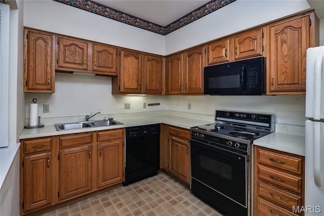 210 N Taylor Ave Unit C, Kirkwood, MO 63122 - kitchen with black appliances, light countertops, and brown cabinets